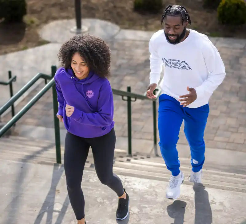 Two people running up stairs.