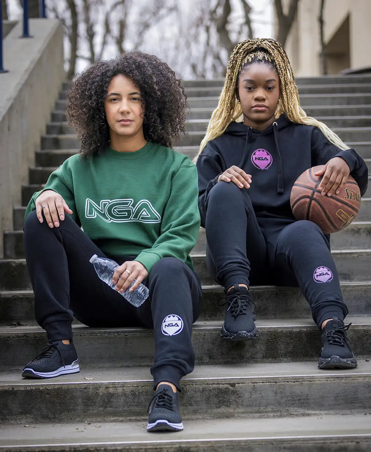 Two women wearing matching athletic outfits.